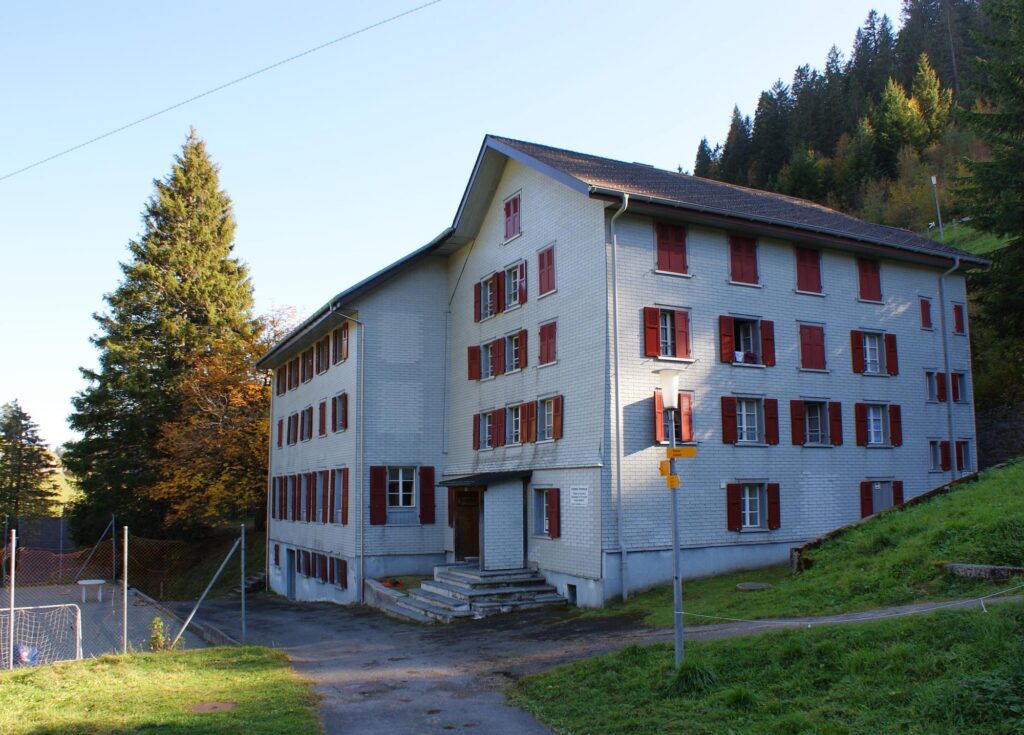 Das Freiämter Ferienhaus mit roten Fensterläden an einem sonnigen Herbsttag
